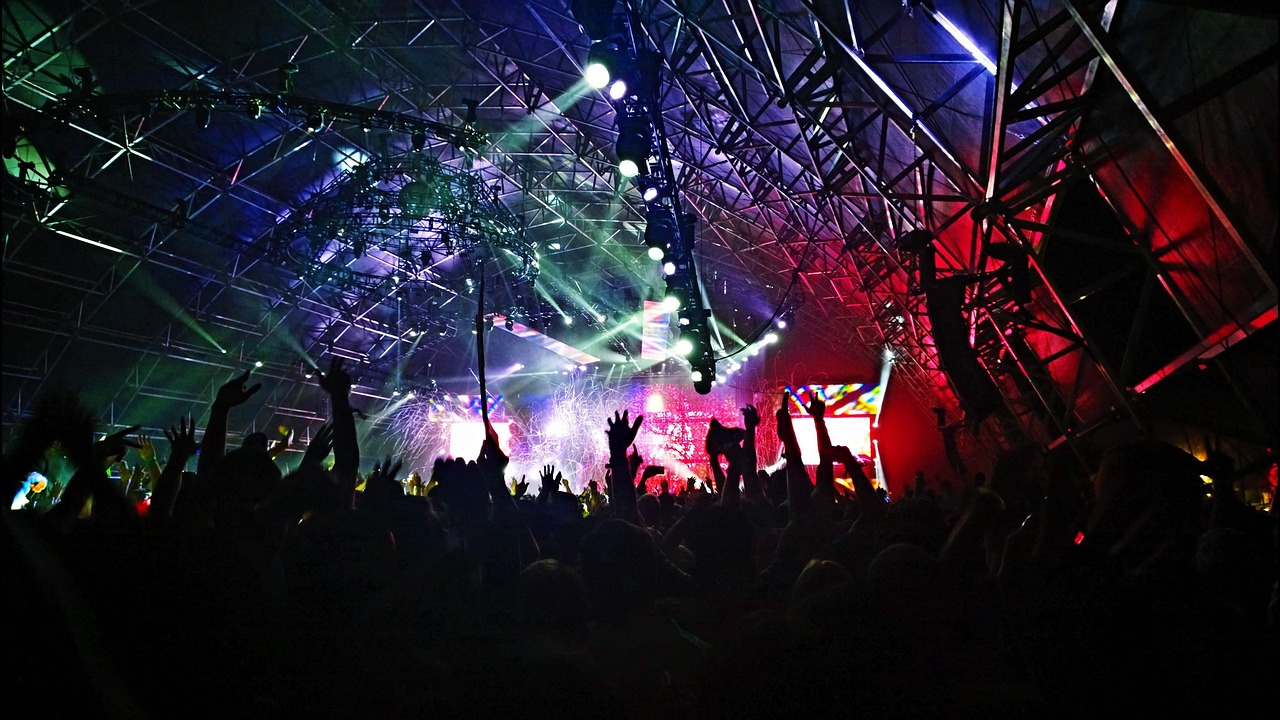 Concert stage with professional lighting rigs and colorful production spotlights